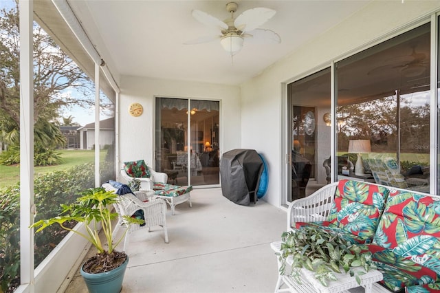 sunroom with a ceiling fan