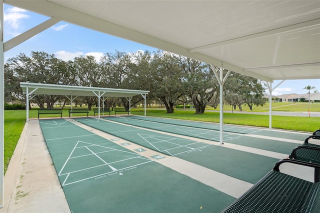 view of property's community with a yard and shuffleboard