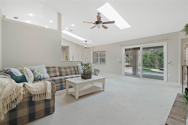 carpeted living room featuring a skylight, baseboards, visible vents, high vaulted ceiling, and recessed lighting