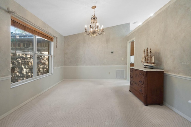 empty room with a notable chandelier, baseboards, visible vents, and light colored carpet