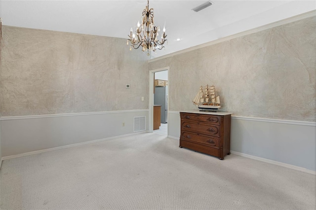 empty room featuring baseboards, a chandelier, visible vents, and light colored carpet