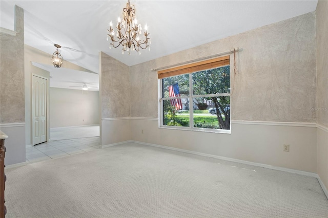 tiled empty room featuring carpet and ceiling fan