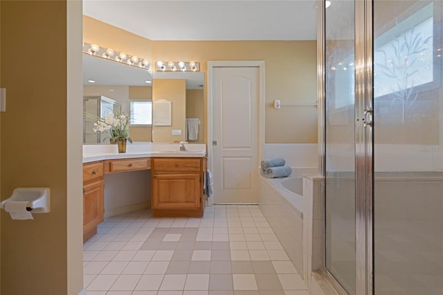 bathroom featuring a stall shower, tile patterned flooring, a garden tub, and vanity