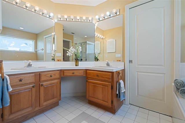 full bathroom featuring a sink, double vanity, a shower stall, and tile patterned floors