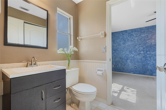 bathroom with visible vents, a wainscoted wall, vanity, and toilet