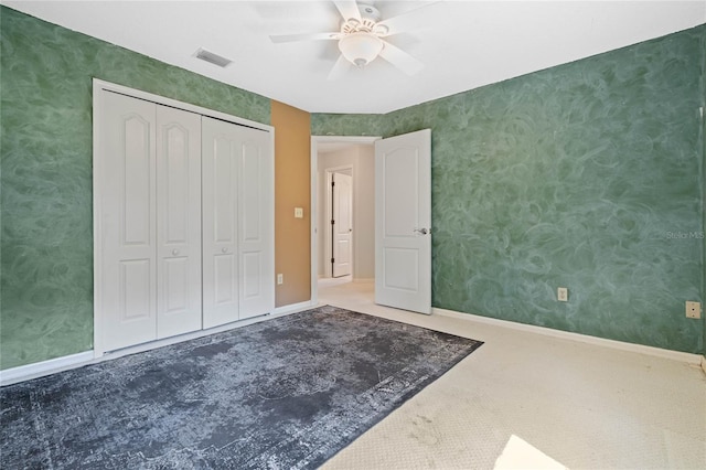 unfurnished bedroom featuring visible vents, baseboards, and wallpapered walls