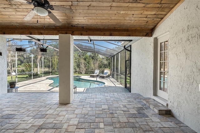 outdoor pool featuring a lanai, a patio area, and ceiling fan