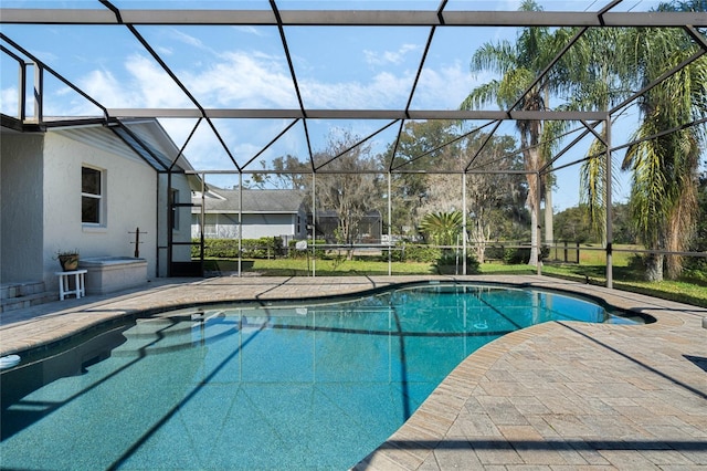 outdoor pool with a patio area and a lanai