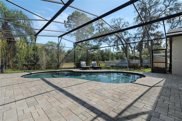 pool featuring a lanai and a patio area