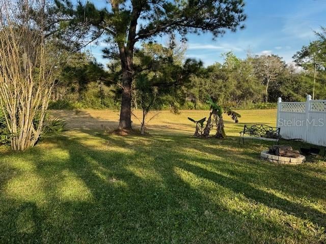 view of yard with a fire pit