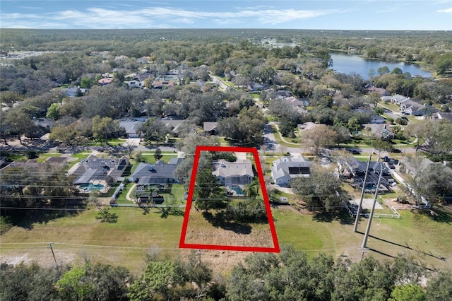 bird's eye view featuring a water view and a view of trees