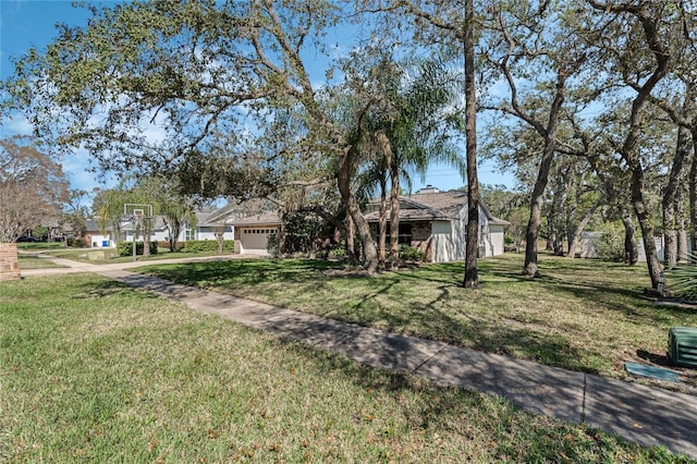 single story home featuring a front yard and an attached garage