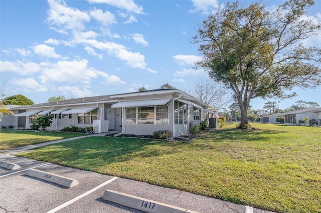 view of front of home with uncovered parking and a front yard