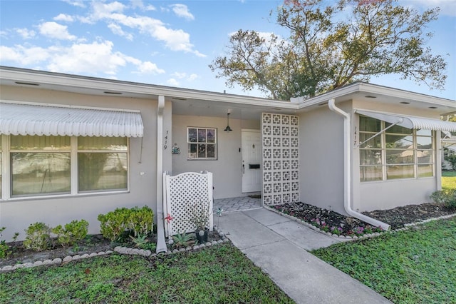 property entrance with stucco siding