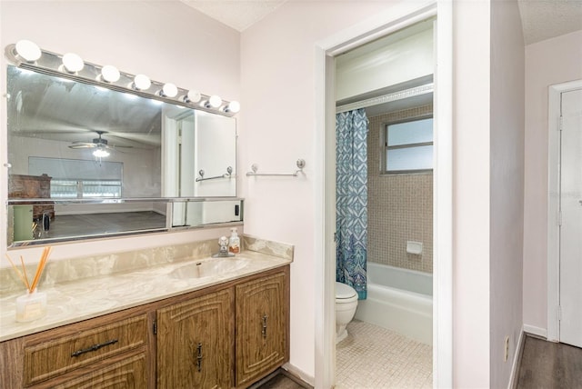 full bathroom featuring toilet, ceiling fan, shower / tub combo with curtain, tile patterned floors, and vanity