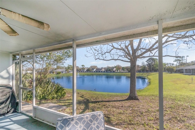 unfurnished sunroom with a water view