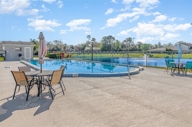 community pool featuring a patio and fence