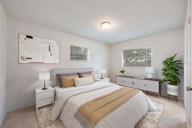 carpeted bedroom with baseboards and a textured ceiling