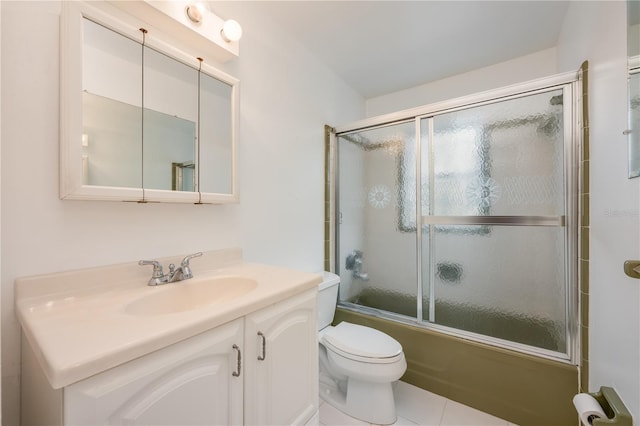 bathroom featuring toilet, enclosed tub / shower combo, and vanity