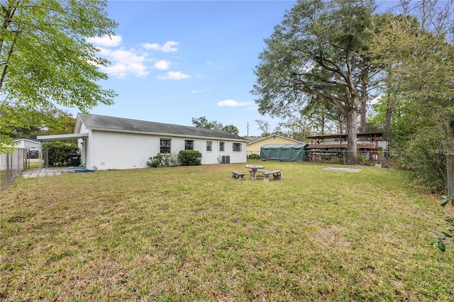 view of yard featuring a carport and a fenced backyard