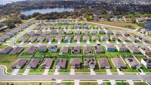 birds eye view of property with a water view and a residential view