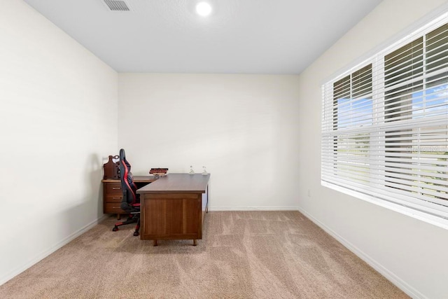 office featuring visible vents, baseboards, and light colored carpet