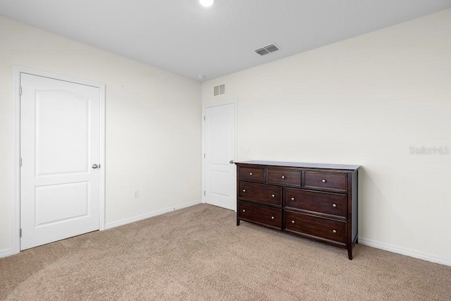 bedroom with light colored carpet, visible vents, and baseboards