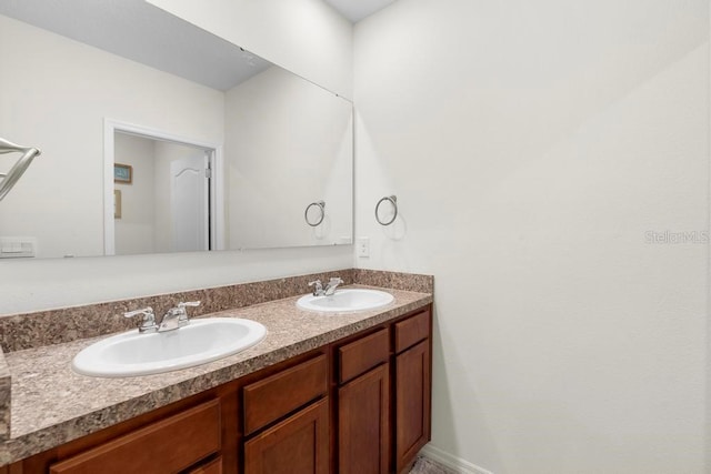 full bathroom featuring a sink and double vanity