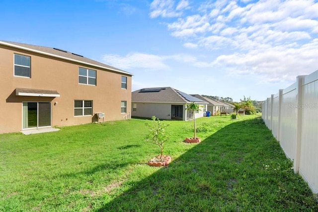 view of yard with a fenced backyard and a residential view