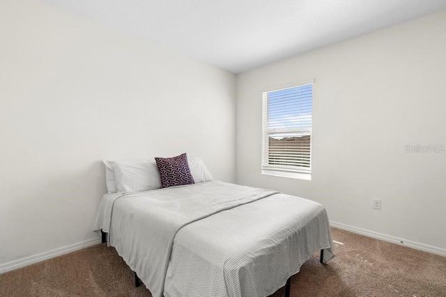 carpeted bedroom featuring baseboards