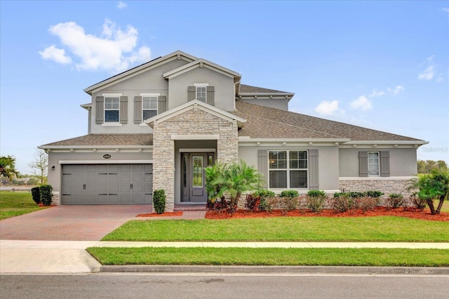 view of front of property featuring stone siding, stucco siding, decorative driveway, and a front lawn