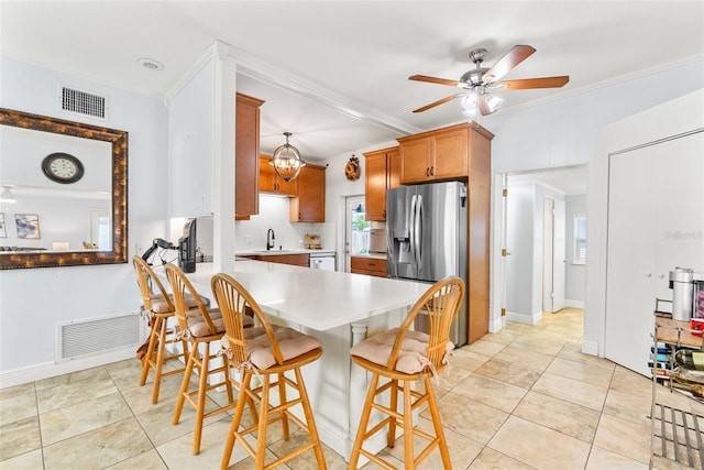 kitchen with a sink, visible vents, stainless steel appliances, and light countertops