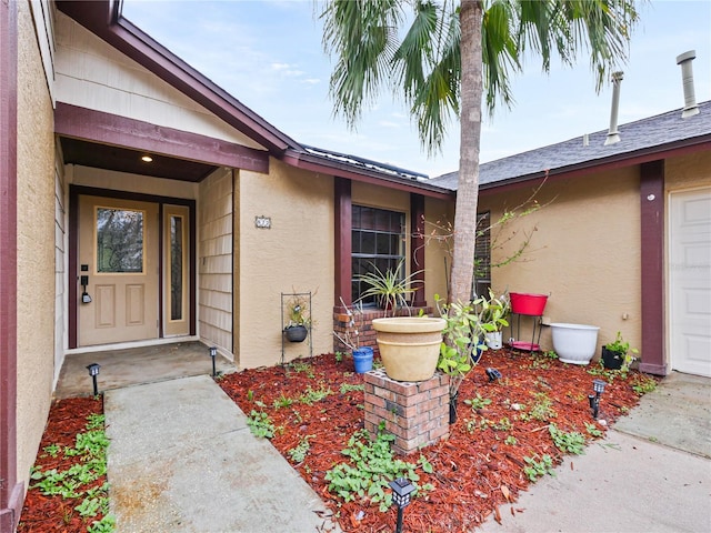 property entrance featuring stucco siding