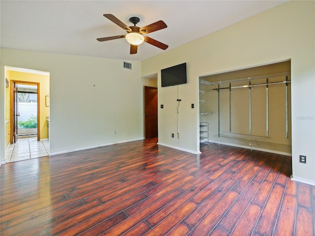 unfurnished bedroom with baseboards, visible vents, and wood finished floors