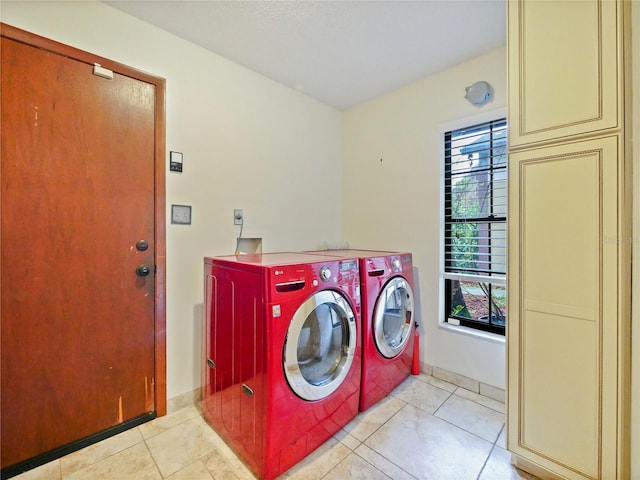 laundry room with light tile patterned floors, laundry area, washer and clothes dryer, and a healthy amount of sunlight