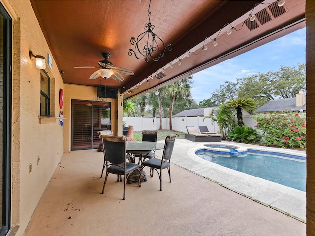 view of patio / terrace featuring ceiling fan, outdoor dining space, a fenced backyard, and a pool with connected hot tub