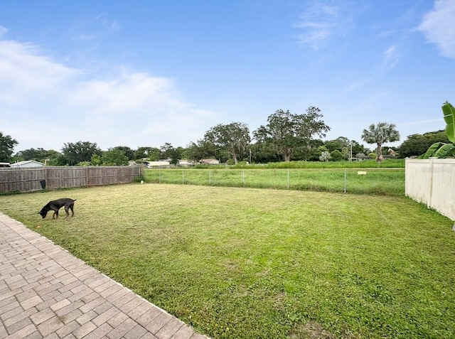 view of yard featuring a rural view and fence