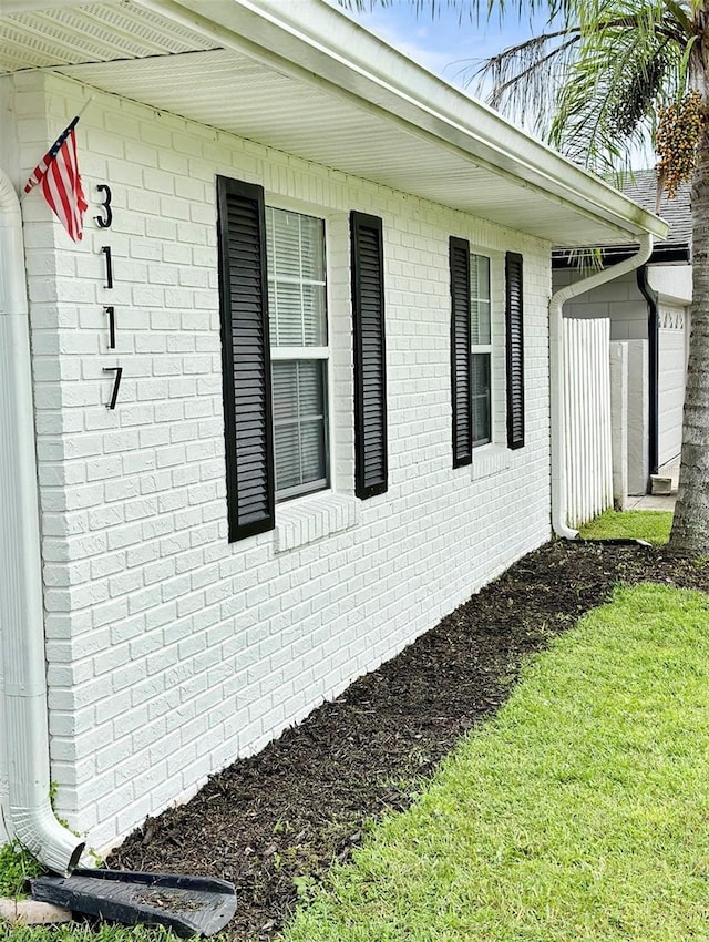 view of side of home featuring brick siding