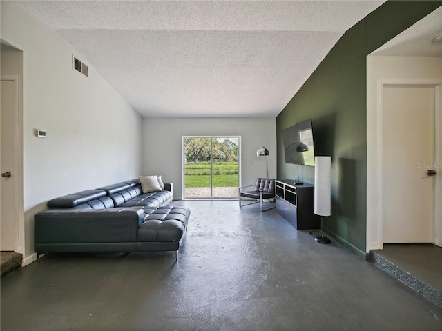 living area with lofted ceiling, visible vents, a textured ceiling, concrete flooring, and baseboards