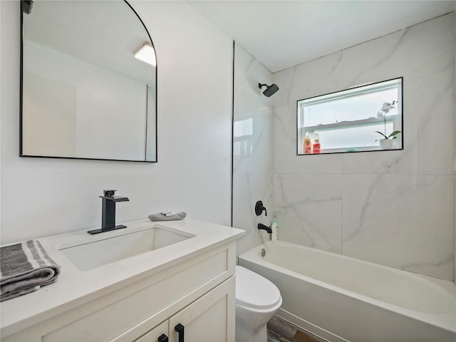 bathroom featuring shower / bathing tub combination, vanity, and toilet