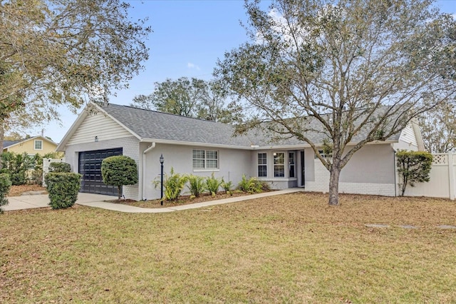 ranch-style home featuring driveway, an attached garage, fence, a front lawn, and brick siding