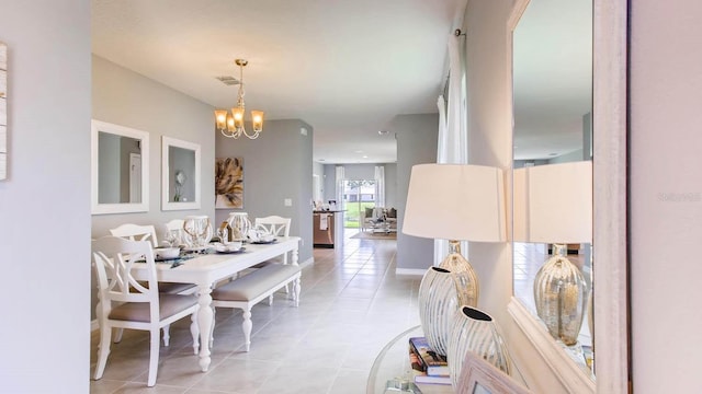 dining space featuring an inviting chandelier, baseboards, visible vents, and light tile patterned flooring