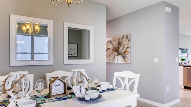 dining area with an inviting chandelier and baseboards