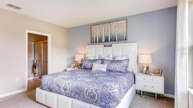 bedroom with light carpet, visible vents, and baseboards