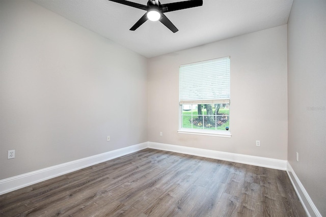 unfurnished room featuring wood finished floors, a ceiling fan, and baseboards