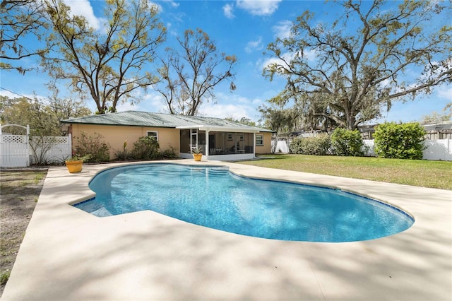 view of swimming pool with a patio, a fenced backyard, a sunroom, a lawn, and a fenced in pool