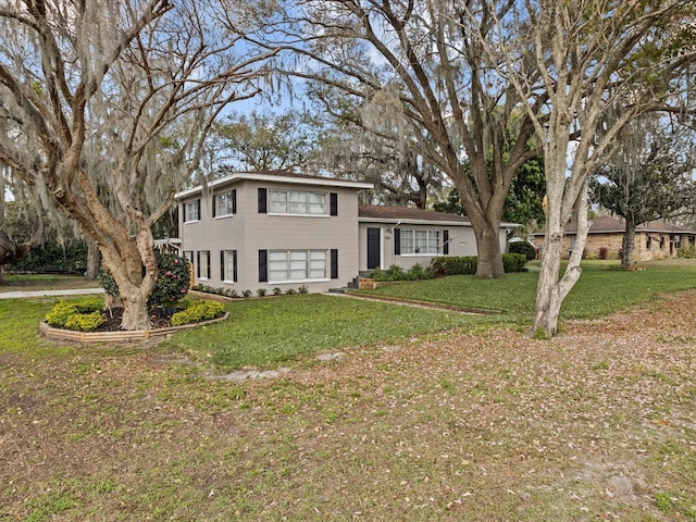 tri-level home with a front yard