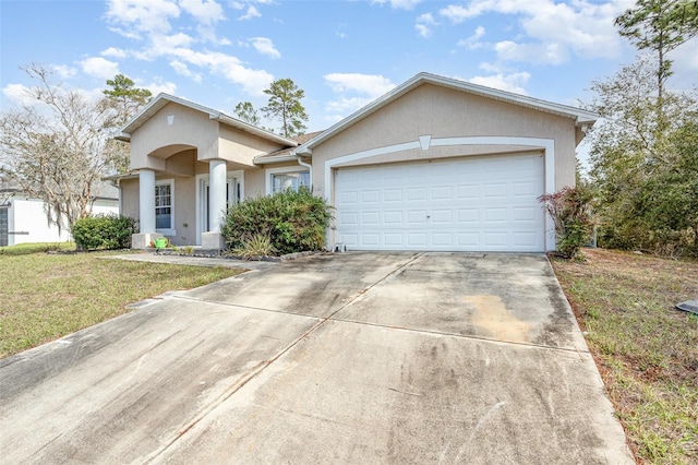 view of front of home featuring driveway, a front lawn, an attached garage, and stucco siding