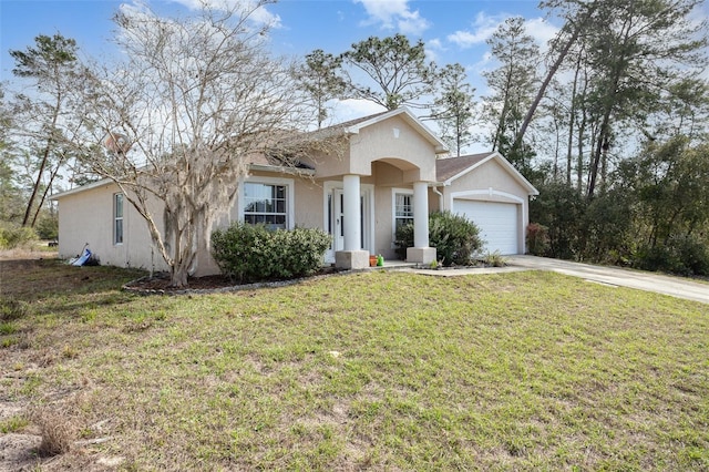 view of front facade with a garage, a front lawn, concrete driveway, and stucco siding