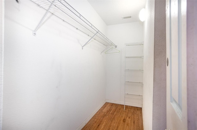 walk in closet featuring light wood finished floors and visible vents